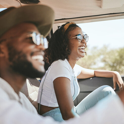 woman and man laughing in a car